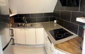 a small kitchen with a sink and a stove at Hotell Trasten Tylösand in Tylösand