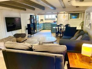 a living room with two couches and a table at Hotell Trasten Tylösand in Tylösand +5 photos