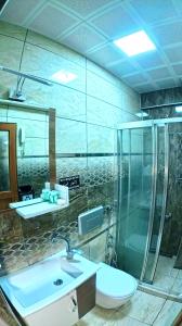 a bathroom with a sink and a shower and a toilet at Goblec Otel in Uzungöl +81 photos