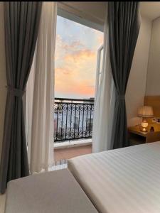 a bedroom with a bed and a view of a balcony at Hotel Dell' Alba in Phú Quốc +32 photos