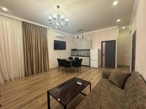 a living room with a couch and a table at Elen Apartment Goris in Goris