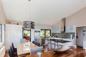a kitchen and dining room with a table and chairs at 10 Kanangra Crescent - Entire in Jindabyne