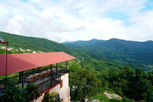 a balcony of a building with mountains in the background at Bandipur Bazar Ghar in Bandipur