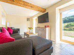 a living room with a couch and a tv at 2 Bed in Crediton oc-72791 in Coldridge