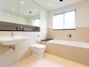 a bathroom with a toilet and a sink and a bath tub at 3 Bed in Bideford oc-52079 in Westward Ho +15 photos