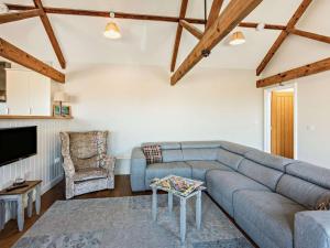 a living room with a couch and a tv at 3 Bed in Umberleigh oc-09092 in Umberleigh Bridge