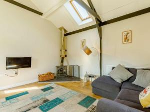 a living room with a couch and a fireplace at 2 Bed in Umberleigh oc-09089 in Umberleigh Bridge