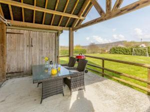 a patio with a table and chairs and a fence at 2 Bed in Umberleigh oc-09089 in Umberleigh Bridge