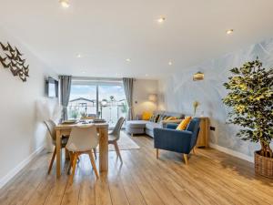 a dining room and living room with a table and chairs at 2 Bed in Bideford oc-65074 in Northam