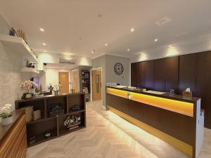 a large kitchen with a counter and a sink at The Suites - St Pancras Hotel Group in London