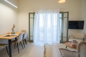 a living room with a table and chairs and a living room at Villa Artemis 5 - Etheras Properties in Kythira