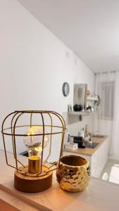 a candle in a cage on a table in a kitchen at Lucy Home in Pisticci