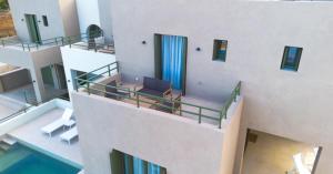 a building with a balcony with a laptop on it at Villa Artemis 5 - Etheras Properties in Kythira