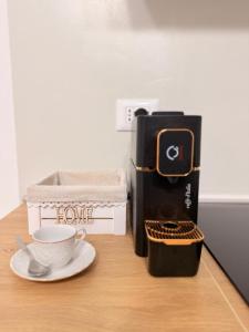 a cup of coffee on a table next to a coffee machine at Lucy Home in Pisticci +33 photos