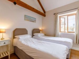 two beds in a small room with a window at 2 Bed in Umberleigh oc-09091 in Umberleigh Bridge