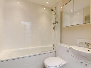 a white bathroom with a tub and a toilet and a sink at 2 Bed in Umberleigh oc-09091 in Umberleigh Bridge +10 photos
