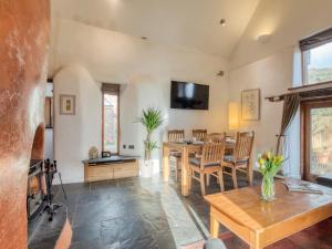 a living room with a table and a dining room at 2 Bed in Tiverton oc-77442 in Washfield