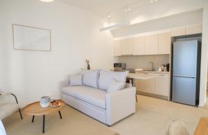 a living room with a white couch and a table at Villa Artemis 5 - Etheras Properties in Kythira
