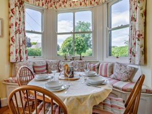 a dining room with a table and chairs and windows at 3 Bed in Brecon oc-bn134 in Brecon