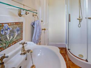a bathroom with a white sink and a shower at 3 Bed in Brecon oc-bn134 in Brecon +24 photos