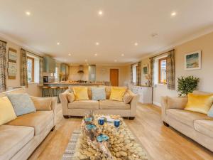 a living room with two couches and a table at 3 Bed in Bideford oc-89865 in Westward Ho