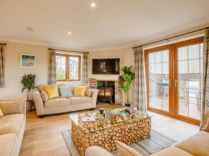 a living room with a couch and a table at 3 Bed in Bideford oc-89865 in Westward Ho