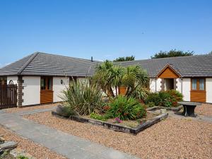 a house with a bench in front of it at 3 Bed in Bideford oc-89865 in Westward Ho