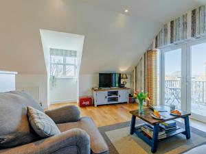 a living room with a couch and a table at 1 Bed in Bideford oc-55340 in Instow