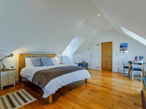 a bedroom with a bed and a table and a desk at 1 Bed in Bideford oc-55340 in Instow