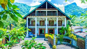 a house with a car parked in front of it at Kitulgala Ebony Riverside Resort in Kitulgala