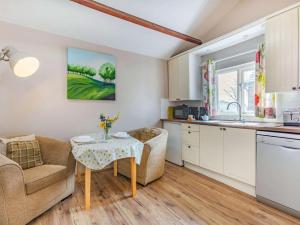 a kitchen and living room with a table and a couch at 1 Bed in Umberleigh oc-09090 in Umberleigh Bridge