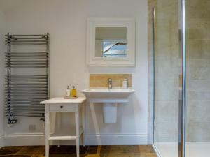 a bathroom with a sink and a shower at 4 Bed in Honiton oc-45563 in Payhembury +20 photos