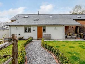 a white house with a fence and a yard at 4 Bed in Honiton oc-45563 in Payhembury