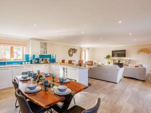 a kitchen and living room with a table and chairs at 3 Bed in Bideford oc-89866 in Westward Ho