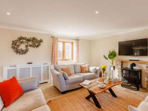 a living room with a couch and a table at 3 Bed in Bideford oc-89866 in Westward Ho