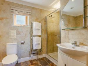 a bathroom with a toilet and a sink and a shower at 3 Bed in Bideford oc-89866 in Westward Ho +12 photos