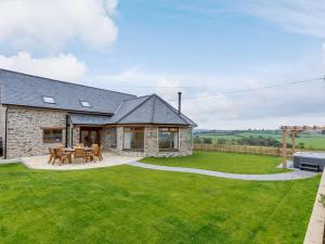 a stone house with a green lawn at 5 Bed in Barnstaple oc-85165 in Charles