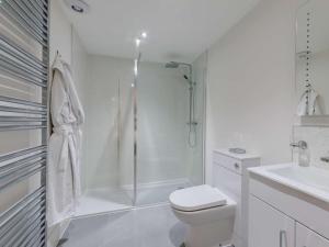 a white bathroom with a shower and a toilet at 5 Bed in Barnstaple oc-85165 in Charles +22 photos