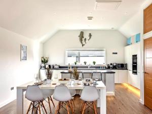a kitchen with a white table and chairs at 3 Bed in Bideford oc-89018 in Westward Ho