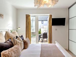 a bedroom with a bed with a television and a table at 3 Bed in Bideford oc-89018 in Westward Ho