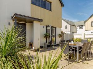a patio with a table and chairs in front of a house at 3 Bed in Bideford oc-89018 in Westward Ho