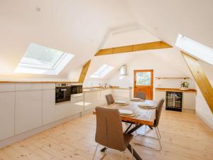 a kitchen and dining room with a table and chairs at 2 Bed in Kings Nympton oc-87985 in Kings Nympton