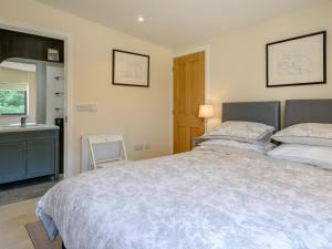 a bedroom with a large bed and a sink at 2 Bed in Crediton oc-78468 in Cheriton Fitzpaine
