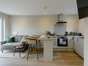 a kitchen and living room with a couch and a table at 1 Bed in Barnstaple oc-91387 in Marwood +15 photos