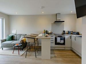 a kitchen and living room with a couch and a table at 1 Bed in Barnstaple oc-91387 in Marwood