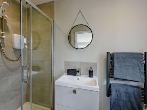a bathroom with a shower and a sink and a mirror at 1 Bed in Barnstaple oc-91387 in Marwood