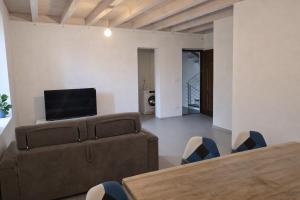 a living room with a couch and a flat screen tv at Galé Suite Apartment in Chieti