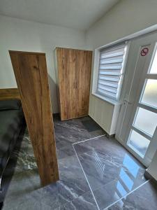 ein leerer Raum mit zwei Holztüren und einem Fenster in der Unterkunft MALM Travnik in Travnik + 52 Fotos