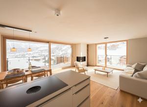 a living room with a couch and a table at Alphubel PEAK in Saas-Fee