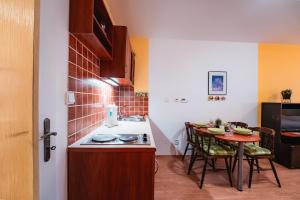 a small kitchen with a table and a counter top at Little Mountain Apartment in Ostružná